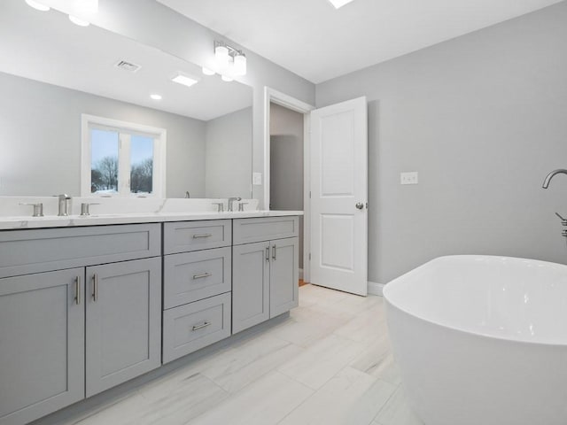 bathroom featuring a tub to relax in and vanity