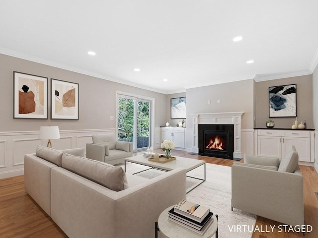 living room featuring light hardwood / wood-style flooring and ornamental molding