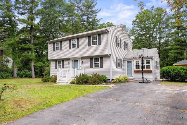 24 Henry J Dr, Tewksbury, MA 01876 - colonial-style house featuring a chimney, a front yard, and driveway
