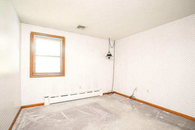 empty room with baseboards, carpet, and a baseboard heating unit