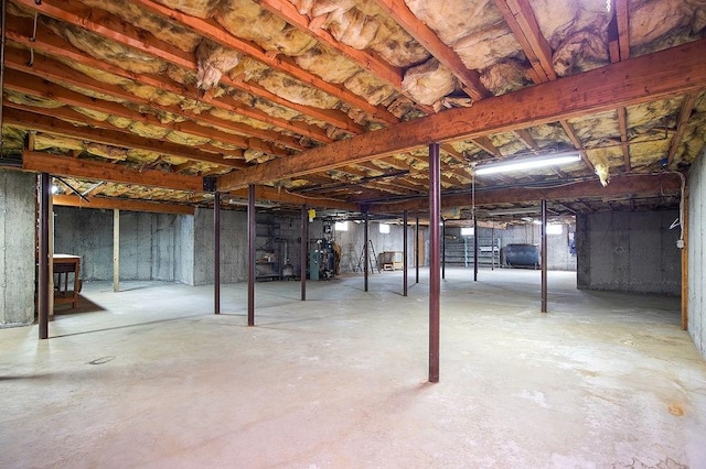 unfinished below grade area featuring heating fuel and water heater