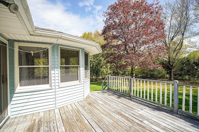 wooden terrace with a lawn