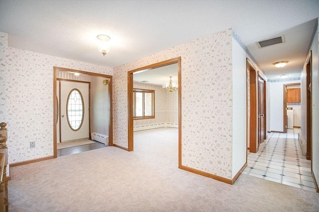 entryway featuring visible vents, a baseboard radiator, a baseboard heating unit, and wallpapered walls