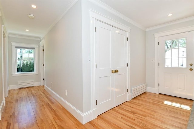 entryway featuring baseboards, ornamental molding, light wood finished floors, and recessed lighting