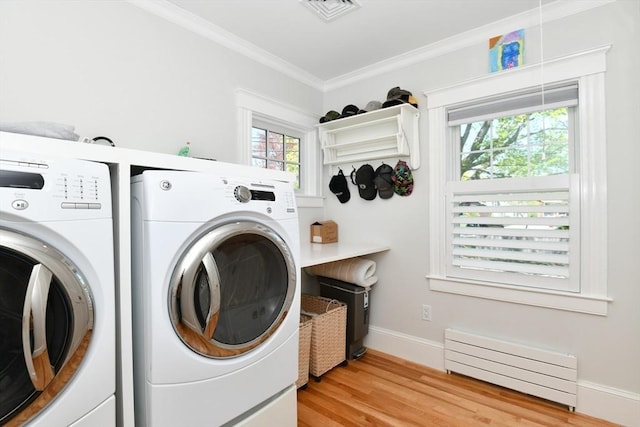washroom featuring washer and clothes dryer, laundry area, ornamental molding, visible vents, and a baseboard radiator