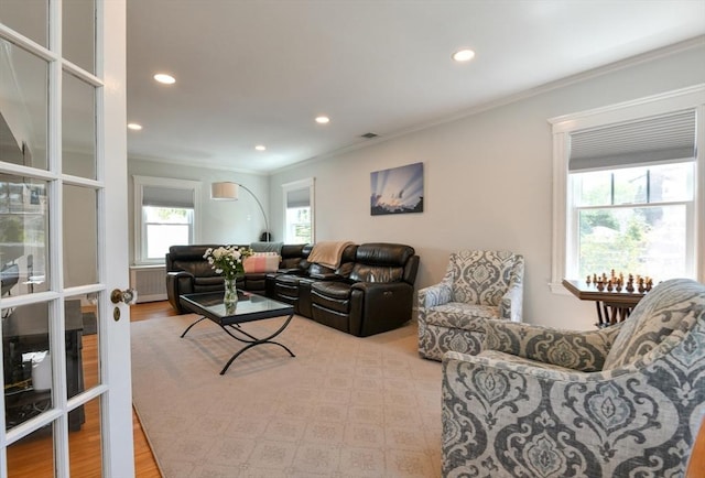 living area featuring ornamental molding, wood finished floors, visible vents, and recessed lighting