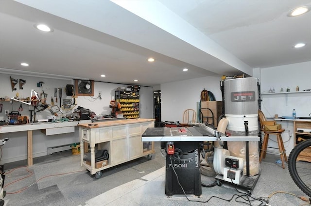 interior space featuring a workshop area, baseboard heating, and recessed lighting