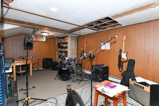 interior space featuring wooden walls, a baseboard radiator, and carpet