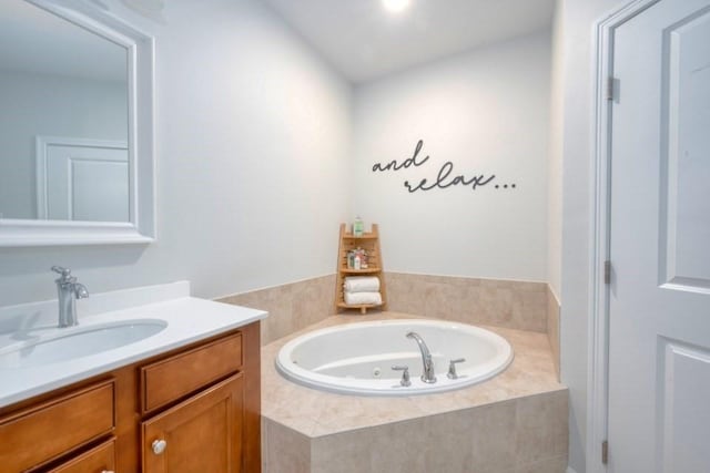 bathroom featuring a jetted tub and vanity