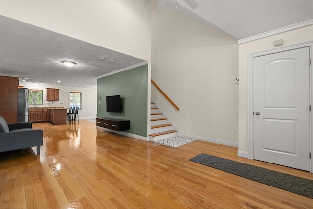 41 Winter Ln Unit 41, Tewksbury, MA 01876 - living room featuring crown molding, light wood-style flooring, stairs, baseboards, and ceiling fan