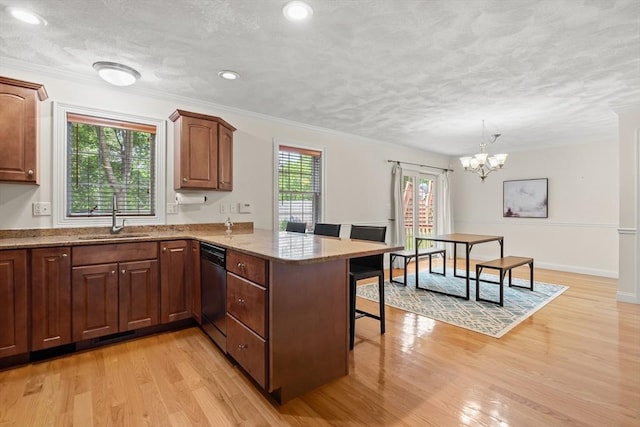 41 Winter Ln Unit 41, Tewksbury, MA 01876 - kitchen with a sink, dishwasher, a kitchen bar, light stone countertops, and a chandelier