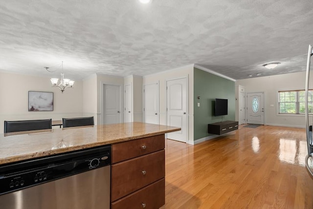 41 Winter Ln Unit 41, Tewksbury, MA 01876 - kitchen featuring dishwasher, a chandelier, light wood finished floors, open floor plan, and light stone counters