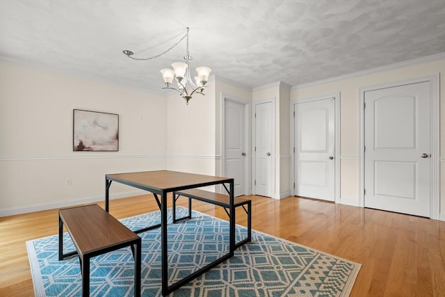 41 Winter Ln Unit 41, Tewksbury, MA 01876 - dining room featuring a chandelier, light wood-style flooring, baseboards, and ornamental molding
