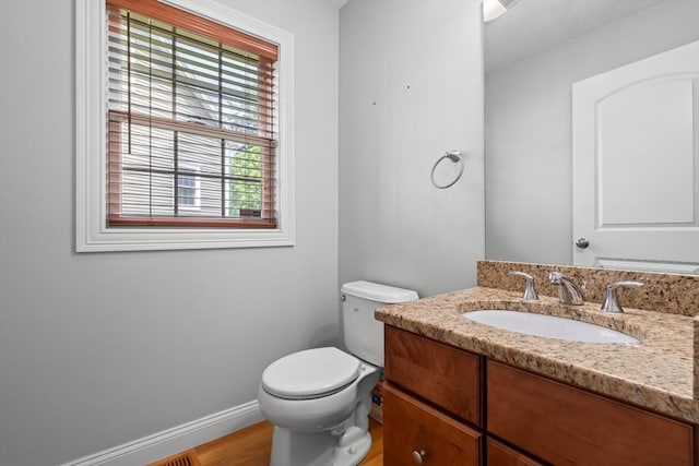 41 Winter Ln Unit 41, Tewksbury, MA 01876 - bathroom featuring vanity, toilet, baseboards, and wood finished floors