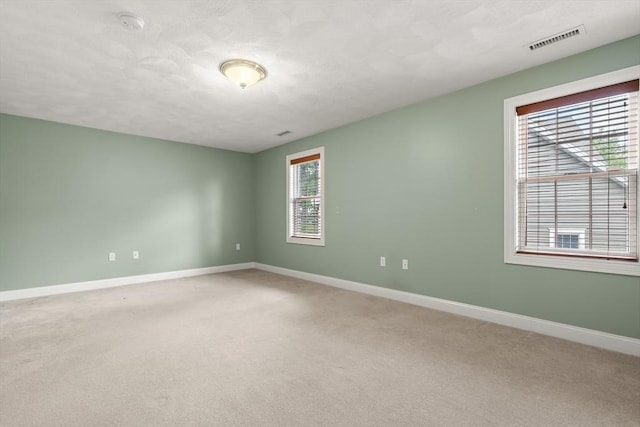 41 Winter Ln Unit 41, Tewksbury, MA 01876 - unfurnished room featuring baseboards, light carpet, a textured ceiling, and a smoke detector