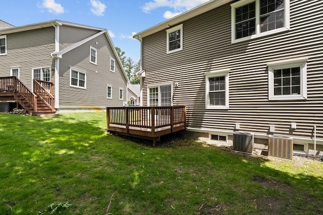 41 Winter Ln Unit 41, Tewksbury, MA 01876 - rear view of house with a wooden deck, central AC unit, and a yard