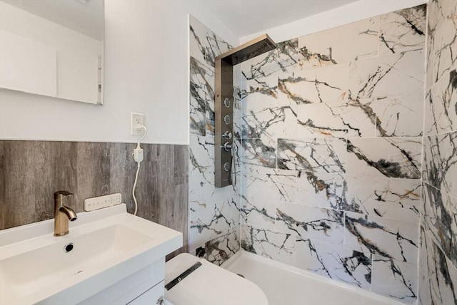 bathroom featuring vanity, toilet, and a tile shower