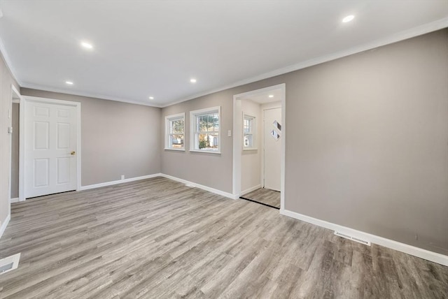 unfurnished room with crown molding and light hardwood / wood-style floors