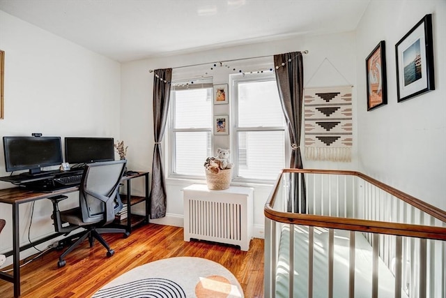 office area featuring radiator and wood finished floors