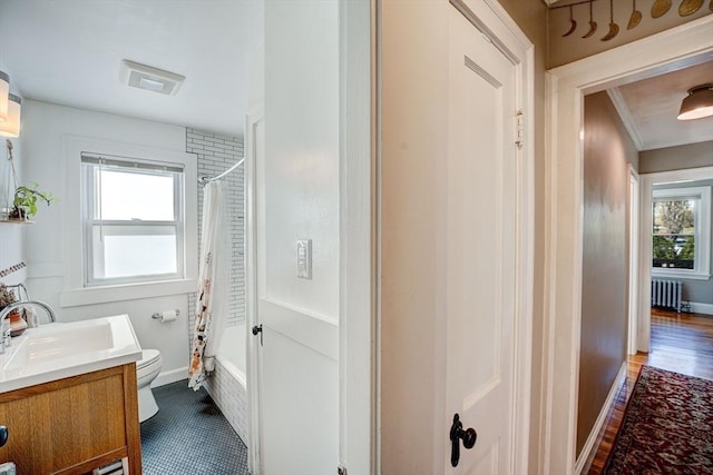 full bathroom with vanity, shower / tub combo with curtain, radiator, visible vents, and toilet