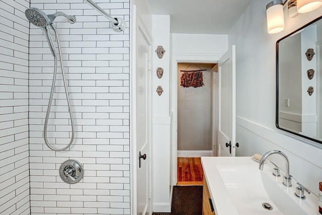 full bathroom with vanity and tiled shower
