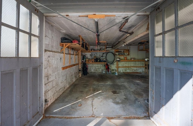 interior space featuring a garage and concrete block wall