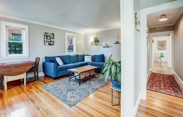 living room with baseboards, ornamental molding, and wood finished floors