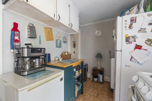 51 Prospect St, Webster, MA 01570 - kitchen with freestanding refrigerator, white cabinetry, and stove