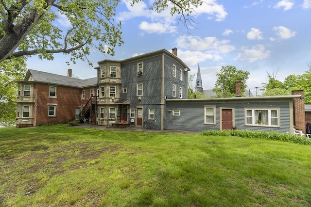 51 Prospect St, Webster, MA 01570 - rear view of house featuring a yard, stairway, and a chimney