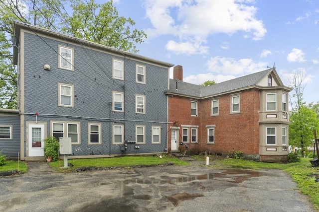 51 Prospect St, Webster, MA 01570 - view of front of house with a chimney and brick siding