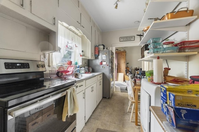51 Prospect St, Webster, MA 01570 - kitchen featuring stainless steel appliances, white cabinets, a sink, light countertops, and light floors
