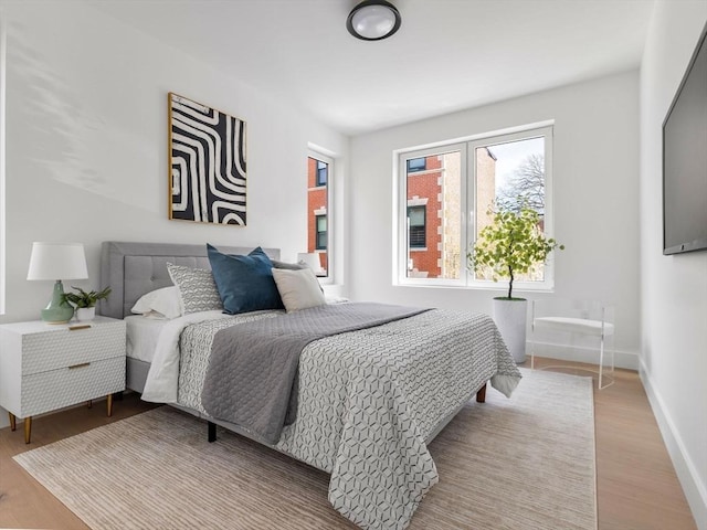 27 Dixwell Unit 12, Boston, MA 02119 - bedroom with light wood-style floors and baseboards