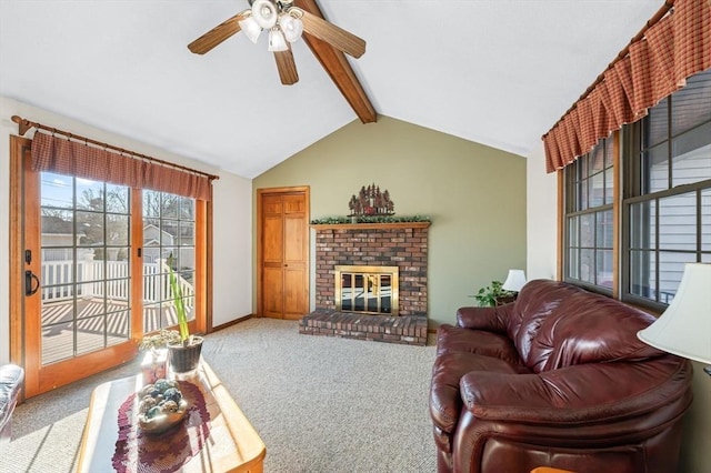 carpeted living room with ceiling fan, vaulted ceiling with beams, and a fireplace