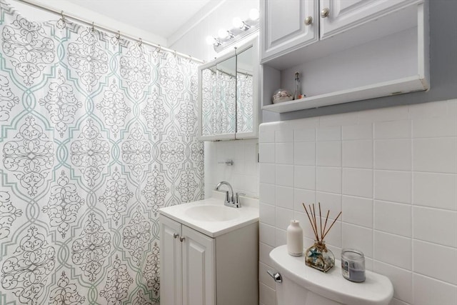 bathroom featuring decorative backsplash, tile walls, toilet, and vanity