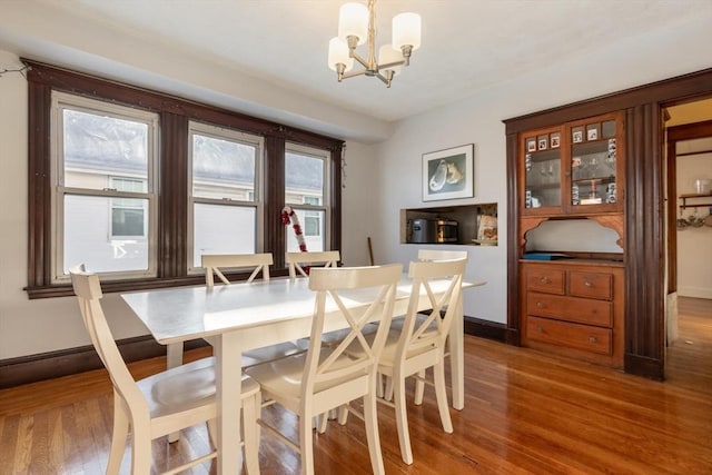 dining space featuring a chandelier and hardwood / wood-style floors