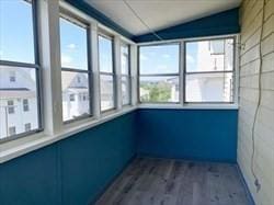 unfurnished sunroom featuring vaulted ceiling