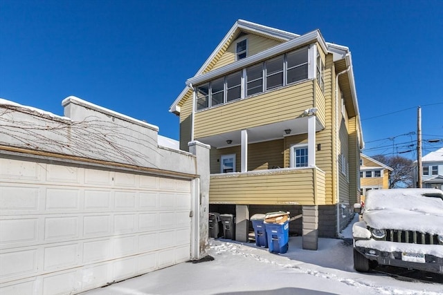 view of front of property with a garage and a balcony