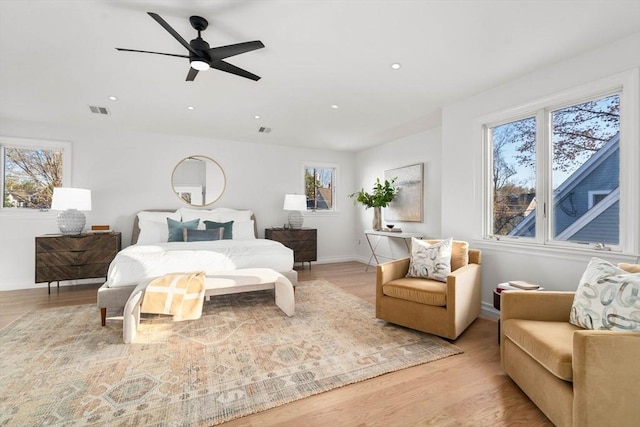 bedroom with ceiling fan and light hardwood / wood-style flooring