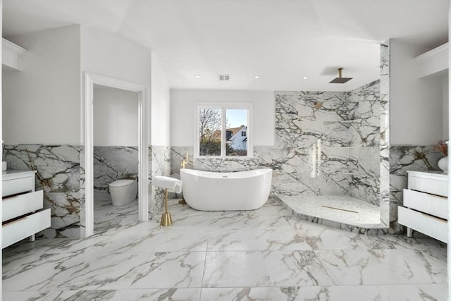 bathroom with tile walls, independent shower and bath, and toilet