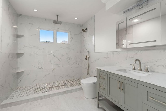 bathroom with vanity, toilet, tile walls, and a tile shower