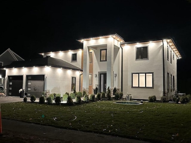 contemporary home featuring a yard and a garage