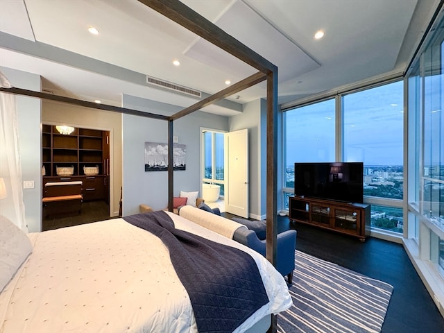 bedroom with a spacious closet and beam ceiling