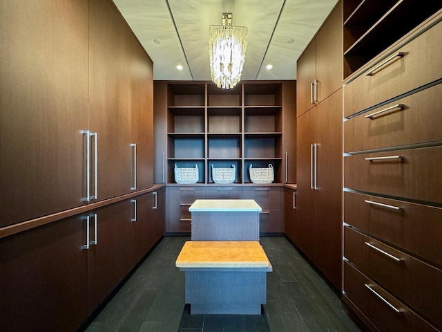 walk in closet featuring a chandelier