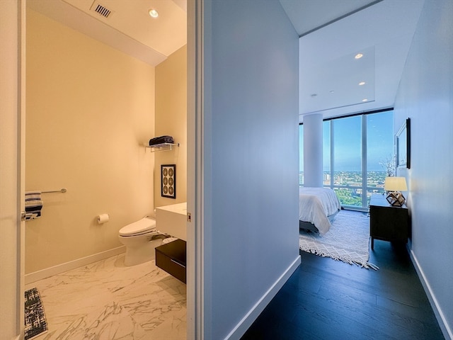 hallway with hardwood / wood-style flooring