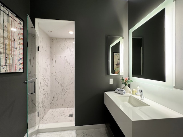 bathroom featuring a shower with door and vanity