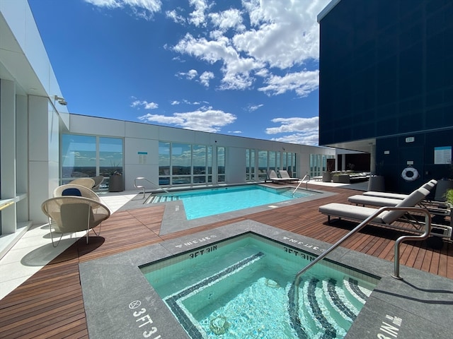 view of swimming pool featuring a hot tub