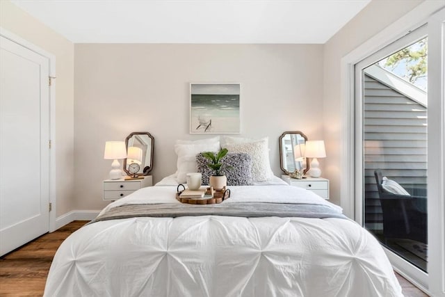 bedroom with dark wood-style floors and baseboards