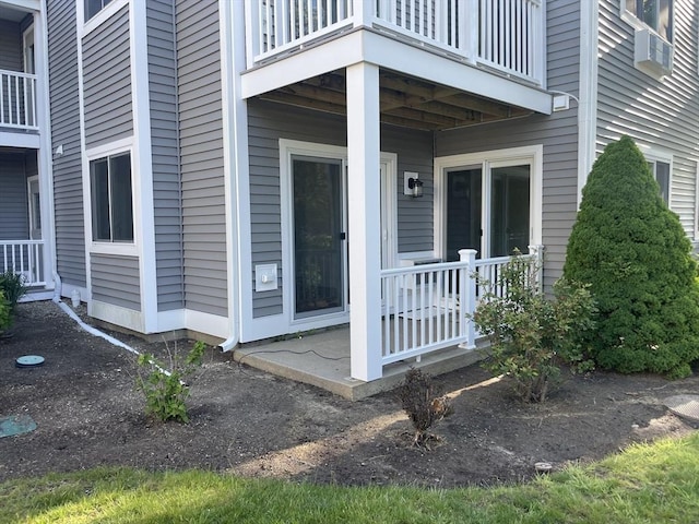 view of exterior entry featuring a balcony
