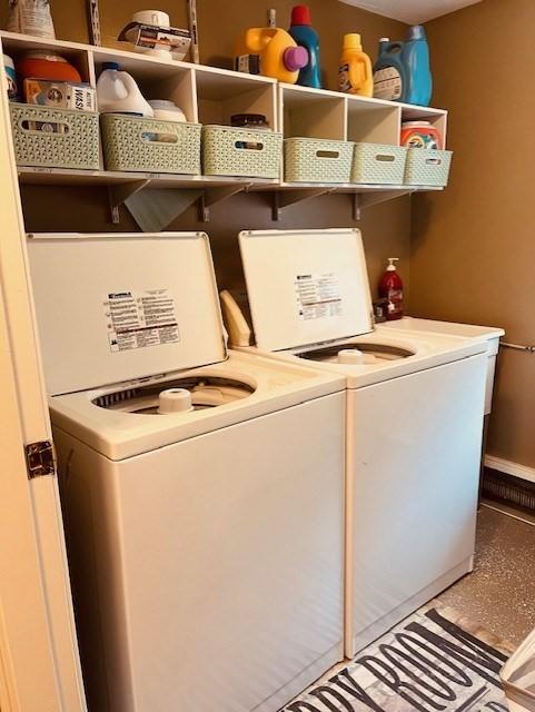 clothes washing area with washing machine and dryer and laundry area