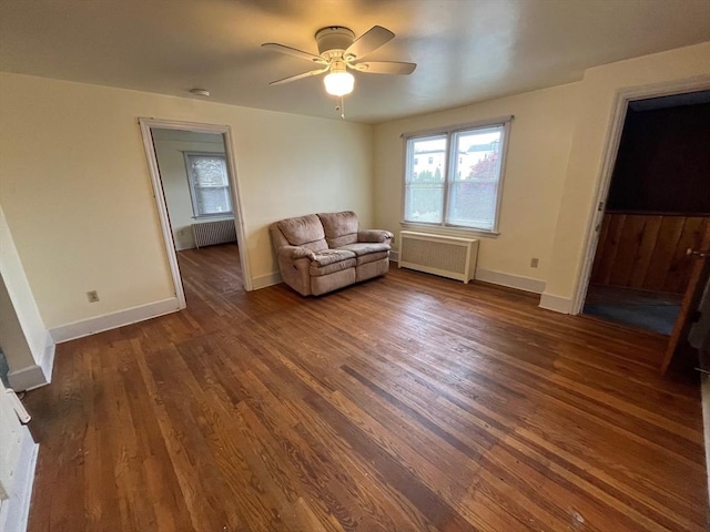 189 Bush St, Fall River, MA 02724 - living area featuring radiator heating unit, wood finished floors, ceiling fan, and baseboards